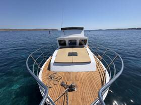 A stunning view of the front deck of a yacht, showcasing its sleek design and beautiful surroundings in clear waters — perfect for luxury cruising.