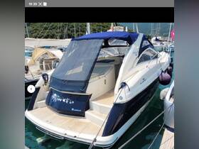 A sleek yacht docked at the marina, showcasing its elegant design and spacious rear deck, perfect for relaxing on the water.