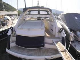 Interior view of a luxurious boat cabin featuring spacious seating and a helm area, perfect for comfortable cruising and relaxation on the water.