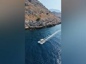 A scenic view of a boat cruising through clear waters, surrounded by rocky cliffs — perfect for exploring coastal landscapes.