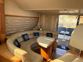 Interior view of a luxurious boat cabin featuring comfortable seating and a stylish lounge area, perfect for relaxing while on the water.