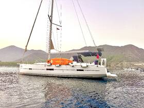 A sleek sailboat anchored in calm waters, surrounded by scenic mountains — perfect for serene sailing adventures.