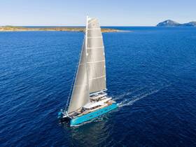 A stunning aerial view of a sleek catamaran sailing through deep blue waters, showcasing its elegant design and perfect for luxury charters or island hopping adventures.