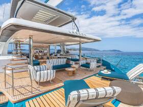 A beautifully designed lounge area on a Lagoon catamaran, featuring stylish seating and a spacious layout, perfect for relaxing while enjoying stunning ocean views.