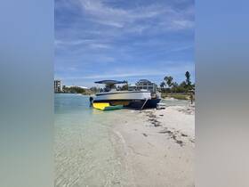 A boat is anchored near the shore on a sunny day, with a person visible on the beach, creating a perfect scene for a day of relaxation and fun on the water.