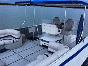 A spacious interior view of a Stiletto 27 boat, showcasing comfortable seating and a well-equipped helm, perfect for relaxing on the water.