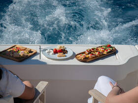 A beautifully arranged selection of snacks and appetizers on a boat, perfect for enjoying while cruising through the waves. Ideal for catering on luxury yacht charters.