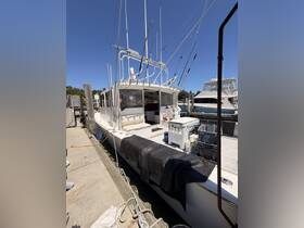 A detailed view of a fishing boat docked at the marina, showcasing its structure and fishing gear — perfect for enthusiasts and charter services.