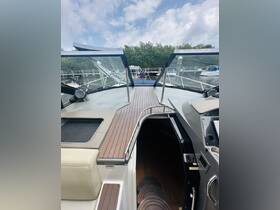 A view of the helm area inside a boat, showcasing the sleek design and modern console, perfect for navigating the waters.