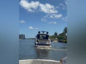 A scenic view of a boat named 'Sea = life' cruising along a waterway, showcasing the beauty of boating in West Palm Beach, FL.