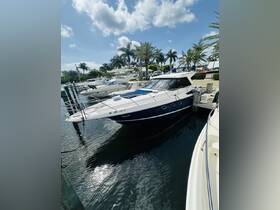 A sleek yacht docked at a marina, surrounded by palm trees and clear skies, perfect for luxury boating experiences.