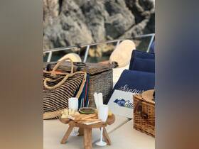 A beautifully arranged picnic setup on a boat featuring snacks and drinks, perfect for enjoying a relaxing day on the water.