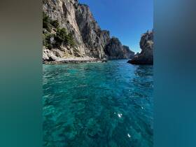 Breathtaking view of turquoise waters framed by dramatic rock formations, showcasing the stunning natural beauty of the coastline.