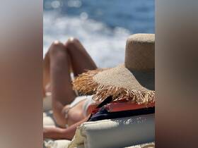 A guest relaxes in the sun on a boat, enjoying the ocean breeze and a moment of tranquility — perfect for a day of leisure on the water.