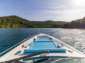 A stunning view from the front of a yacht cruising through serene waters, surrounded by lush greenery — perfect for exploring coastal landscapes.