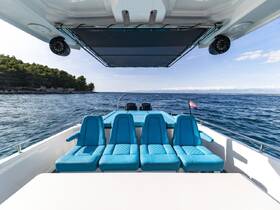 A spacious interior view of a boat featuring comfortable blue seating and a clean helm area, perfect for relaxing while enjoying the open water.