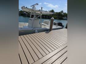 A detailed view of a center console boat docked at a marina, showcasing its sleek design and surrounding tranquil waters.