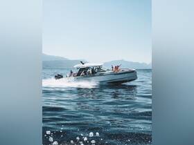 A lively group enjoys a day on the water, celebrating aboard a sleek boat, perfect for summer adventures and fun outings.
