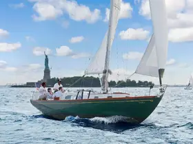 A group enjoys a sailing experience on a yacht near the iconic Statue of Liberty, capturing the essence of a memorable day on the water.
