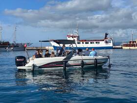A lively group enjoys a day out on a boat in the harbor, perfect for social gatherings and exploring the waters.