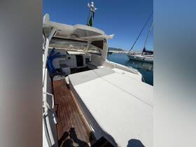 A spacious interior view of a boat's lounge area, featuring comfortable seating and a well-designed helm, perfect for relaxing on the water.
