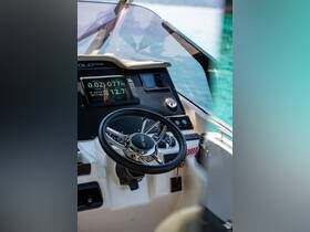 A detailed view of the helm and console of a modern boat, showcasing the steering wheel and navigation instruments — perfect for those looking to explore boating technology.