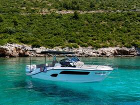A sleek speedboat anchored in crystal-clear waters, surrounded by lush greenery — perfect for summer adventures and exploring coastal landscapes.