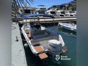 A sleek boat docked at the marina, showcasing its elegant design and features — perfect for day trips or leisurely cruises.
