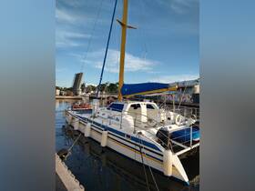 A vibrant catamaran named 'Haven't Me' docked at the marina, showcasing its colorful design and ready for adventures on the water.