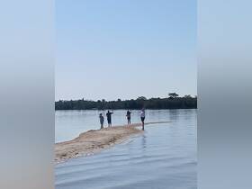 A group of friends enjoys a sunny day at a sandbar, capturing memories and celebrating together in the water — a perfect getaway for fun and relaxation.