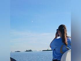 A person captures a stunning view of the sky while enjoying a boat ride, showcasing the beauty of the surrounding scenery.