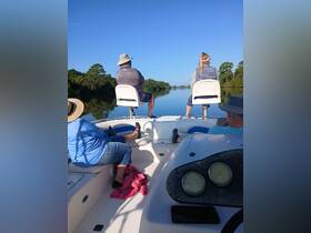 A group enjoys a serene boating experience, taking in the beautiful scenery while relaxing on the water. Perfect for a peaceful day out with friends or family.