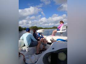 A family enjoys a relaxing day on a boat, surrounded by scenic waterways and blue skies — perfect for creating lasting memories on the water.