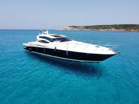A stunning aerial view of a sleek yacht cruising through crystal-clear turquoise waters, perfect for luxury charters and island adventures.