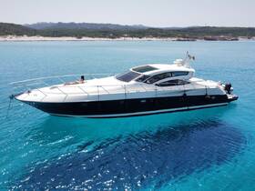 A stunning aerial view of a luxurious yacht with a guest lounging on the bow, surrounded by crystal-clear waters — perfect for sun-soaked adventures and relaxation.