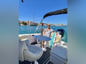 A stylish woman relaxes in the interior of a boat, showcasing comfortable seating and a scenic waterfront view — perfect for leisurely outings on the water.