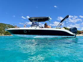 Two friends relax on a boat in crystal-clear turquoise waters, enjoying a perfect summer day on the water.