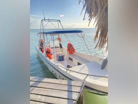 A serene view of a boat named 'La Tora' docked in calm waters, showcasing its structure and safety gear, perfect for a day of adventure on the water.