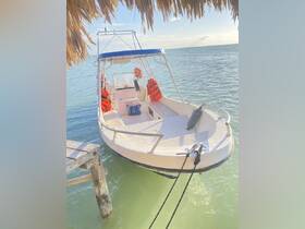A well-maintained boat docked in calm waters, showcasing its structure and safety gear, ideal for fishing or leisure trips.