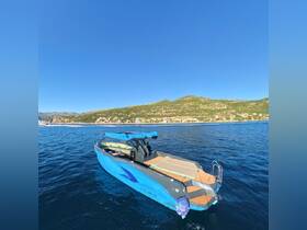 A sleek blue yacht cruising through clear waters with a scenic coastline in the background, perfect for luxury outings and adventures on the sea.