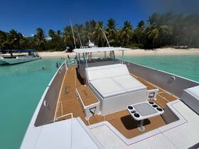 A vibrant scene at a tropical beach with guests enjoying the water near a pontoon boat, perfect for group outings and fun in the sun.
