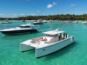 A lively group enjoys a day on the water with multiple boats anchored in stunning turquoise waters, perfect for swimming and relaxation.