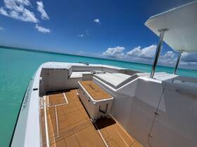 A bright and spacious interior view of a boat, showcasing comfortable seating and a well-designed helm area, perfect for enjoying a day on the water.
