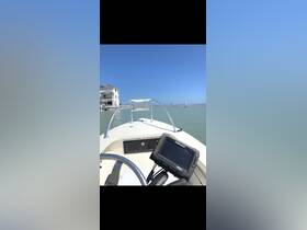 A view from the helm of a boat, showcasing the console and surrounding water, ideal for navigation and fishing trips.