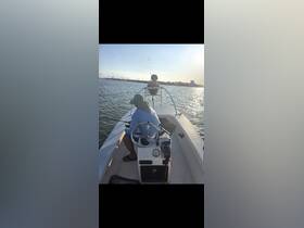 A serene fishing trip on a boat at sunset, featuring a child and an adult enjoying quality time together while casting lines into the water.