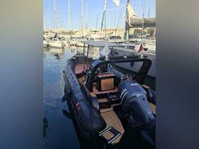 A sleek speedboat docked in a marina, showcasing its stylish design and wooden accents, surrounded by other vessels.