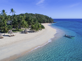 A stunning aerial view of a secluded beach with crystal-clear turquoise waters and lush greenery, perfect for tropical getaways and island adventures.