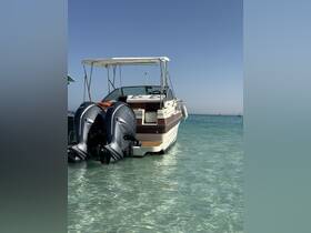 A beautiful boat docked in clear turquoise waters, showcasing its sleek design and powerful engines — perfect for a day of adventure on the water.