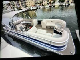 Interior view of a spacious pontoon boat featuring comfortable seating and a helm, perfect for leisurely outings on the water.