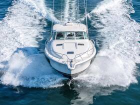 A striking aerial view of a speedboat cutting through the waves, showcasing its sleek design and powerful performance on the water.